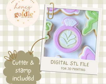 May include: A digital STL file for 3D printing, featuring a pink ring-shaped cookie cutter with a diamond and leaf design. The image includes the text "Cutter & stamp included" and "DIGITAL STL FILE FOR 3D PRINTING". The logo "honey & goldie DESIGNS" is also visible.