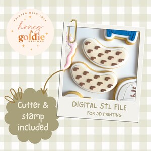 May include: Image of a digital STL file for 3D printing, featuring decorated cookies. The cookies are shaped like jelly beans with brown square accents. The image includes the text "Cutter & stamp included" and the brand name "honey & goldie designs".