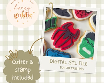 May include: A collection of superhero-themed cookies, including a red spider design, displayed in a polaroid-style frame. The image also features the text "DIGITAL STL FILE FOR 3D PRINTING" and "Cutter & stamp included."
