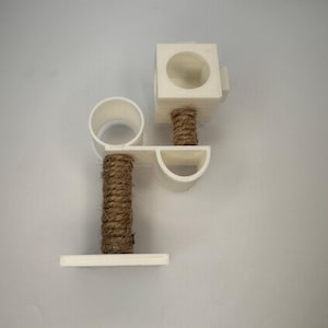 May include: White cat scratching post with two platforms and a sisal rope covered post.