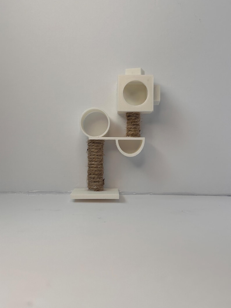 May include: White cat tree with a round platform, a square platform with a hole, and a sisal rope scratching post.