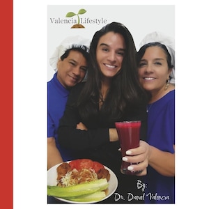 May include: A group of three people smiling, wearing blue and white chef hats. One person holds a glass of red juice. A plate of food with lettuce, tomatoes, and other ingredients is in the foreground. The text "Valencia Lifestyle" and "By: Dr. Daniel Valencia" are visible.