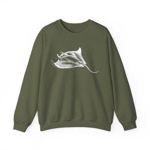 May include: An olive green sweatshirt with a white illustration of a manta ray. The design shows the manta ray's shape and features. The sweatshirt has a crew neck and long sleeves, suitable for cooler weather.