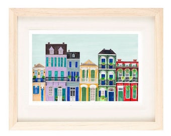 May include: A watercolor painting of a row of colorful houses with balconies and green plants. The houses are painted in shades of purple, green, yellow, and red.