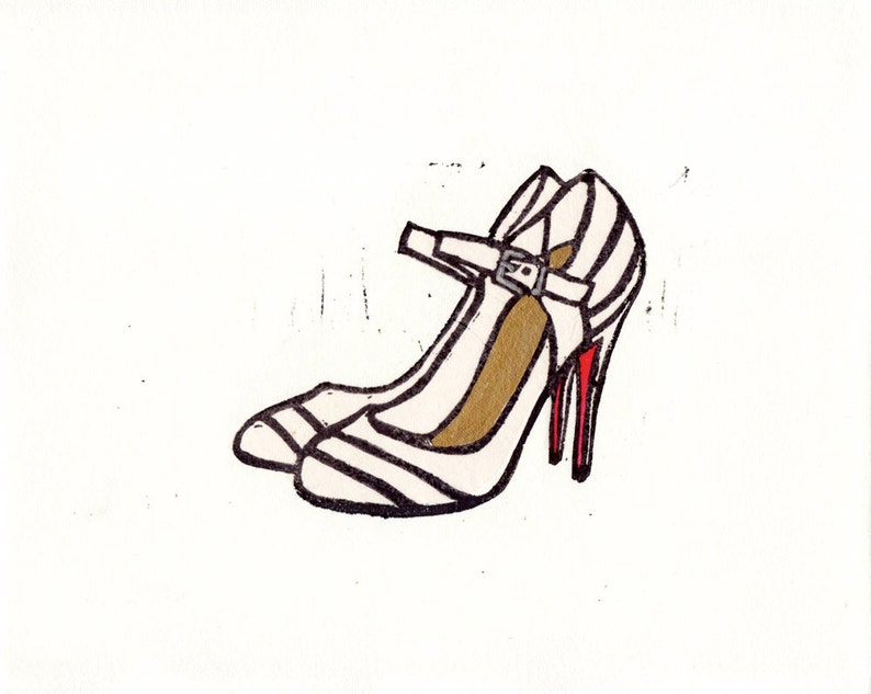 May include: A pair of white heeled shoes with black stripes and a red heel. The shoes have a strap with a buckle.