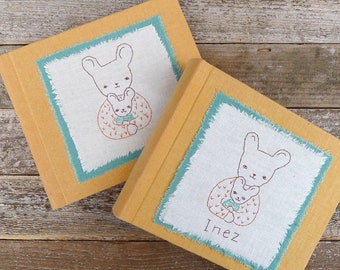 photo album covered in plant-dyed organic cotton/hemp fabric: yellow with hand-embroidered bunnies, plain or personalized by kata golda