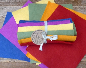 May include: A set of 6 bright colored wool felt squares, rolled up and tied with a white ribbon. The label reads "Wool Felt 6 bright colors 100% Wool Felt Made in Nepal"