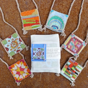 May include: A set of 7 colorful embroidery kits with a white background. The kits are small and square shaped with a variety of geometric patterns. The kits are labeled "Stitch the Design DIY Kit" and "kata golda handmade".