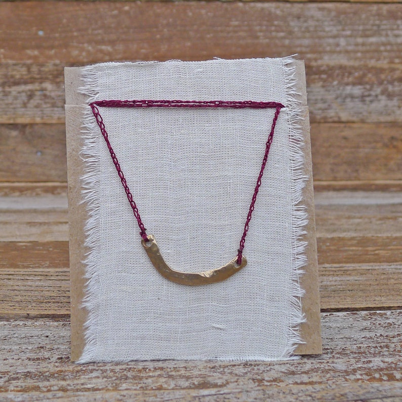hand cast yellow bronze charm on adjustable crocheted cord basin necklace by kata golda