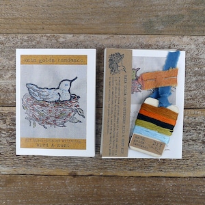 May include: A DIY hand-stitched bird and nest kit by Kata Golda Handmade. The kit includes a block-printed fabric panel, embroidery floss, a needle, and instructions.