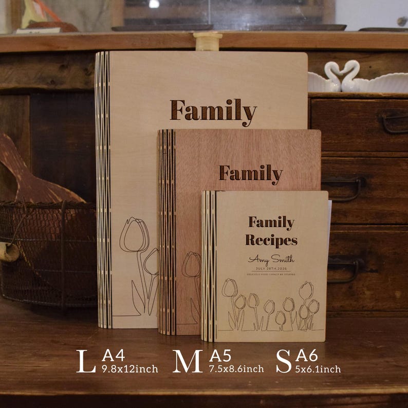 May include: Wooden recipe books in various sizes, labeled L, M, and S. The largest book is 25x30.5cm, with the word "Family" engraved on the cover. The smallest book is labeled "Family Recipes" with the name Amy Smith.