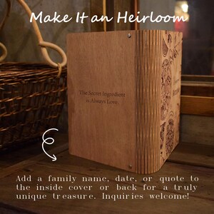 May include: A wooden box with the text "Make It an Heirloom" and "The Secret Ingredient is Always Love." The box has decorative etched designs on the side. The text at the bottom says, "Add a family name, date, or quote to the inside cover or back for a truly unique treasure."