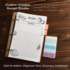 May include: A custom wooden recipe binder with a 3-ring design. The binder includes designed recipe pages and 16+ free customizable tabs. The recipe pages have illustrations of vegetables and the word "RECIPE" at the top. The binder is on a wooden surface.