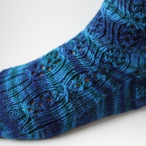 May include: Blue and green striped knitted socks with a lacy pattern.