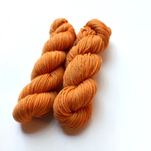 May include: Two skeins of orange yarn, wound into balls.