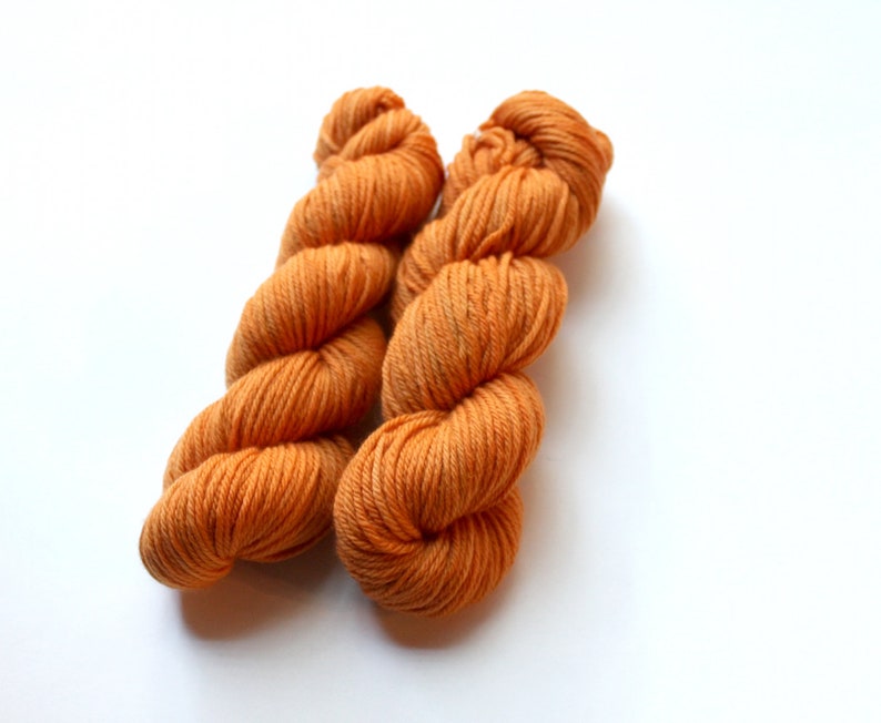 May include: Two skeins of orange yarn, wound into balls.