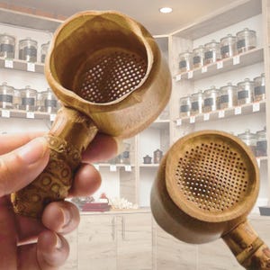 May include: Two wooden tea infusers with a mesh strainer. The infusers are made of natural bamboo and have a round shape. The infusers are perfect for brewing loose leaf tea.