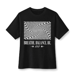 May include: A black short-sleeve t-shirt featuring a white graphic of a distorted, wavy checkerboard pattern. Below the graphic, the text reads BREATHE. BALANCE. BE. with a small decorative element consisting of two stars and a tiny checkerboard icon.