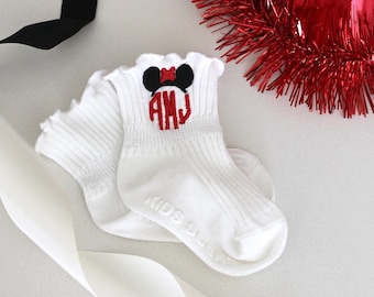 May include: A pair of white ankle socks with a red and black embroidered Mickey Mouse head and the monogram "AHJ".