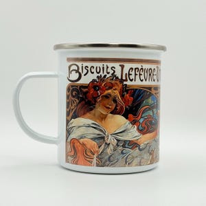 May include: White enamel mug with a silver rim and handle. The mug features a vintage advertisement for "Biscuits Lefèvre-Utile" with an Art Nouveau illustration of a woman with flowers in her hair.