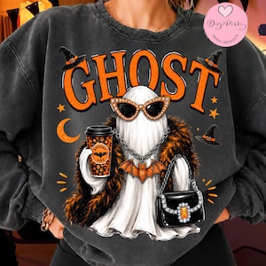 May include: A charcoal grey crewneck sweatshirt featuring a graphic of a white ghost wearing orange cat-eye sunglasses, a silver chain with a bat pendant, and a faux fur stole. The ghost holds a leopard print coffee cup and a black handbag.