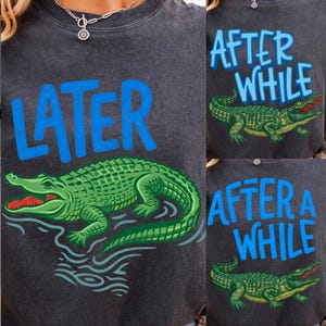 May include: Dark gray sweatshirt with a green alligator graphic and the word "LATER" in blue. The alligator has a red mouth and is in water. The sweatshirt also has the text "AFTER WHILE" and "AFTER A WHILE" with a similar alligator graphic.