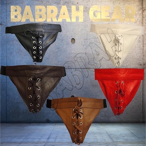 May include: Five leather jockstraps in black, white, brown, tan, and red. Each jockstrap features a lace-up front and a wide waistband. The text "BABRAH GEAR" is at the top of the image.