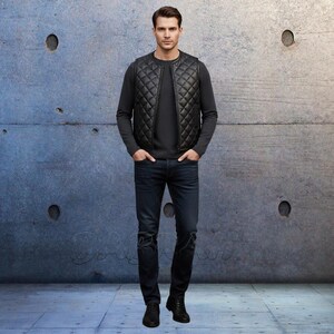 May include: A man wearing a black quilted vest over a dark gray long-sleeve shirt and dark blue jeans. The vest has a diamond pattern. The jeans have a distressed design on the knees. He is wearing black boots.