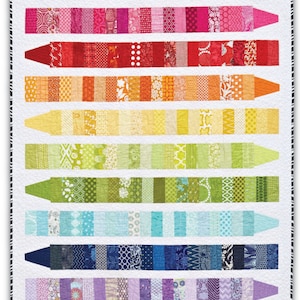 May include: A patchwork quilt with crayon designs in a rainbow of colours, including pink, red, orange, yellow, green, blue, and purple. The quilt has a white background and a black and white patterned border. The text "COLOR ME" is at the top.