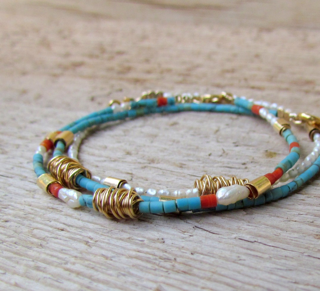 JP545 - Gold bracelet with coral pearls and turquoise.