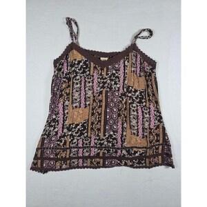 May include: A sleeveless camisole top featuring a dark brown base with a multi-colored patchwork pattern of floral, paisley, and geometric motifs in shades of pink, tan, and cream. The neckline and hem are finished with a dark brown crochet trim.