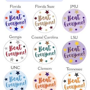 May include: A collection of round buttons with the text "Beat Everyone!" and star graphics. Each button features a different college team's colors and logo, including Florida, Florida State, JMU, Georgia, Coastal Carolina, LSU, UNC, Clemson, and Tennessee.