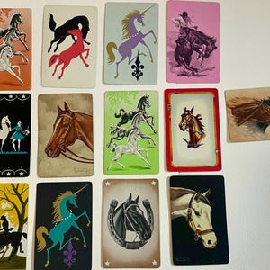 13 playing cards of horses and few unicorns