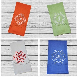 May include: Four kitchen towels with embroidered monograms in different colors. The towels are white, orange, green, and blue. The monograms are in a decorative script font. The text "Five Star Fonts.com" is visible in the bottom right corner of each towel.