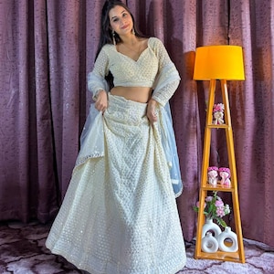 Look drop dead gorgeous in this beautiful off white lehenga set