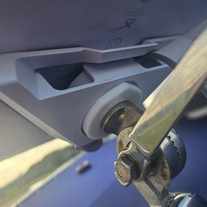 May include: A white plastic mount with a silver metal arm attached to it. The mount has a small white plastic knob on the side. The arm is attached to a silver metal base.