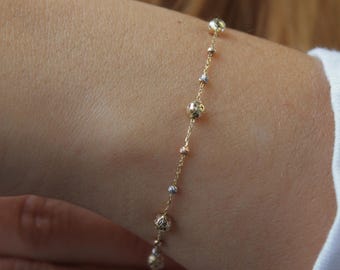 Bransoletka z kulką Dorica z żółtego złota 14k: delikatny łańcuszek