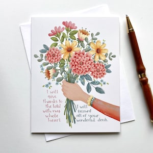 May include: Greeting card with a floral bouquet illustration. The card features a hand holding a bouquet of pink, yellow, and peach flowers. Text on the card reads, "I will give thanks to the Lord with my whole heart. I will recount all of your wonderful deeds."