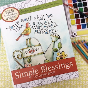 May include: A coloring book cover with a watering can, a bird, and flowers. The title is "Simple Blessings Coloring Book" and the text reads "Your soul shall be like a well watered garden."