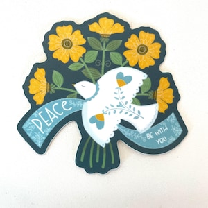 May include: A teal blue sticker with a white dove flying with a blue ribbon that says "Peace be with you". The dove is surrounded by yellow flowers with green stems and leaves.