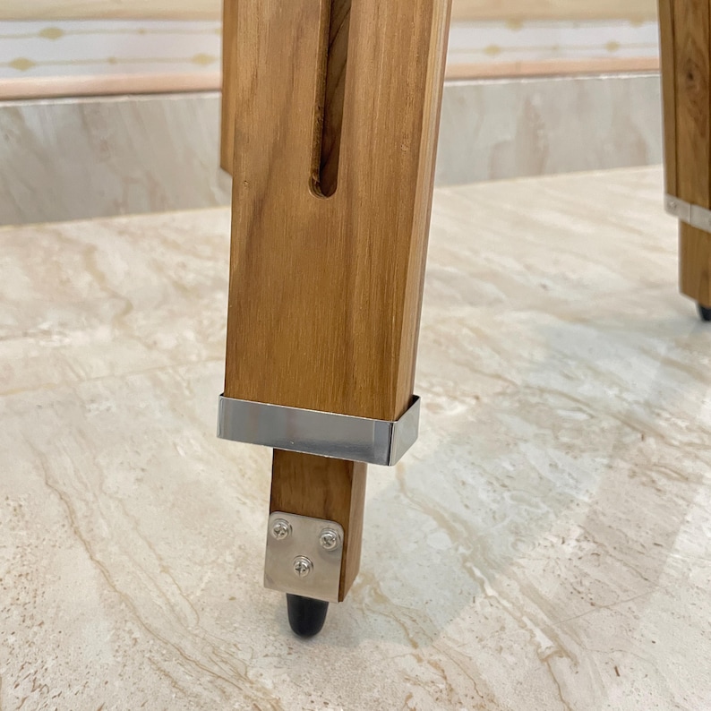 Vintage-style adjustable tripod stand handcrafted from premium teak wood with polished aluminium and nickel hardware. Features three sturdy wooden legs, an adjustable center column, and a height range of 25 to 50 inches. Ideal for DIY photo booths, DSLR cameras, floor lamps, studio décor, and nautical-inspired interiors. Handcrafted wooden tripod with a timeless industrial design.