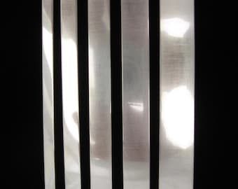 May include: Five silver metal strips of varying widths labeled 1/4, 3/8, 1/2, 5/8, and 3/4.