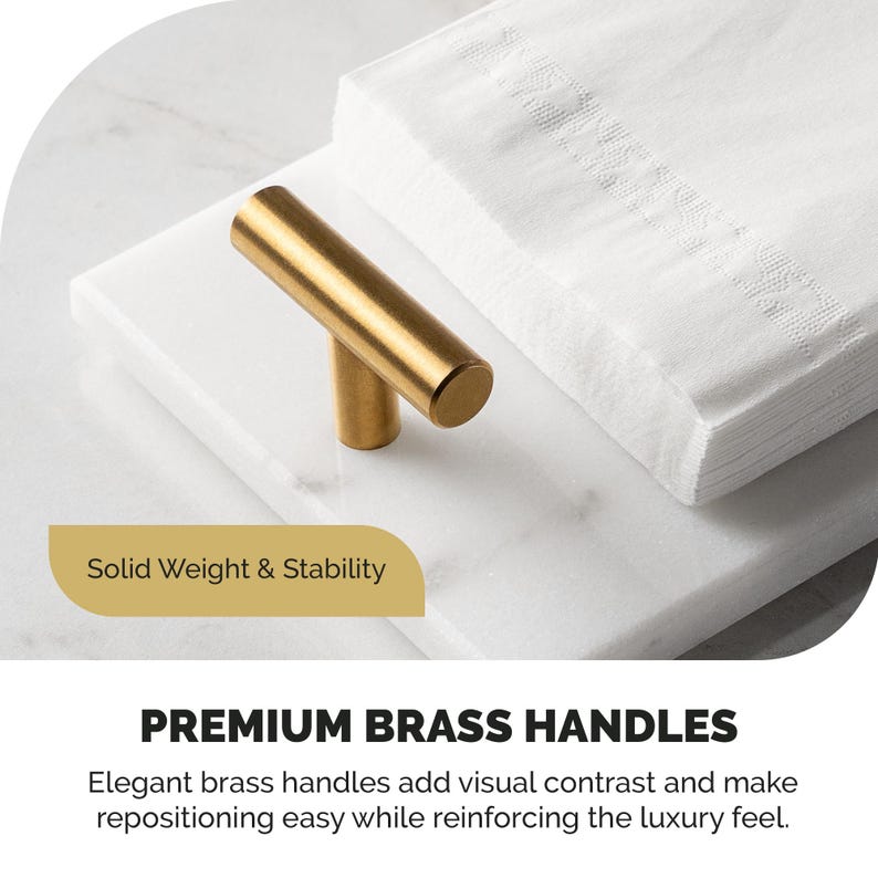 May include: A gold-colored brass handle with a cylindrical design, resting on a white marble surface. A stack of white napkins is in the background. The text "PREMIUM BRASS HANDLES" is visible.