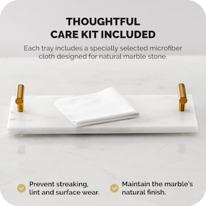 May include: A rectangular white marble tray with gold-colored handles. A white microfiber cloth rests on the tray. Text on the image reads "THOUGHTFUL CARE KIT INCLUDED" and "Prevent streaking, lint and surface wear."