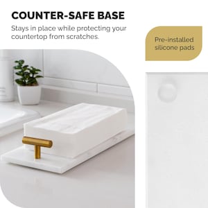 May include: A white marble tray with a gold-colored handle, holding a stack of white paper. The text "COUNTER-SAFE BASE" and "Pre-installed silicone pads" are visible. The tray is designed to protect countertops from scratches.