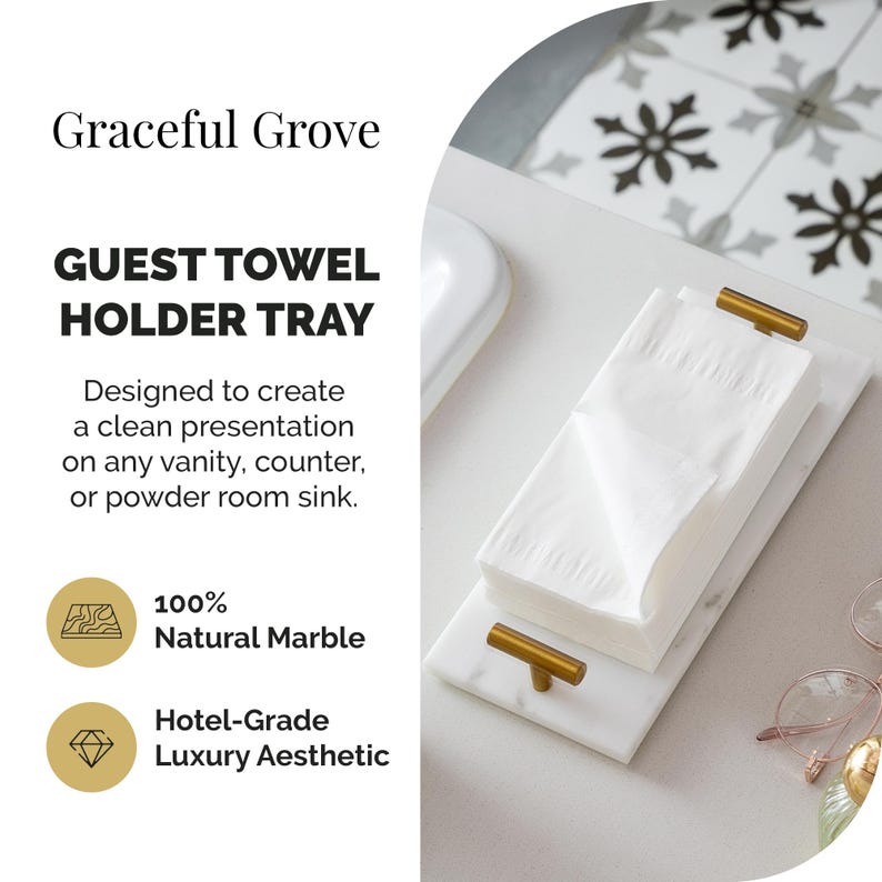 May include: A white marble guest towel holder tray with gold-colored handles. The tray holds a stack of white guest towels. The text on the image reads "Graceful Grove" and "GUEST TOWEL HOLDER TRAY". The tray is made of 100% natural marble.