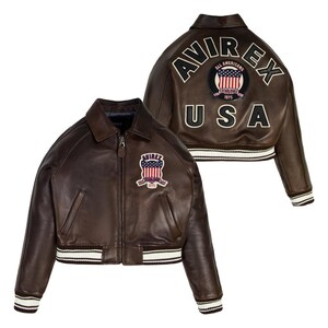 May include: A brown leather jacket with a zip closure, featuring a white and black striped hem and cuffs. The jacket has a patch on the chest and back with the text "AVIREX" and "USA".
