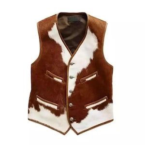 May include: A brown and white cowhide vest with a V-neck and four silver-coloured buttons. The vest has two front pockets and a brown lining. The cowhide pattern is a mix of brown and white patches.