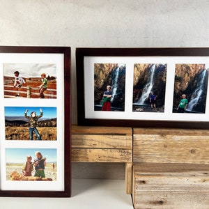 May include: Two dark brown wooden picture frames with white matting. The vertical frame holds three landscape photos of children outdoors. The horizontal frame holds three portrait photos of a child standing in front of a large waterfall.
