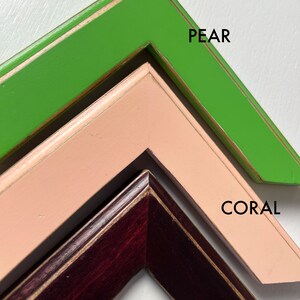 May include: Three angled corner sections of picture frames in different colors. The top frame is bright green labeled PEAR, the middle frame is light coral labeled CORAL, and the bottom frame is dark reddish-brown wood labeled MAHOGANY.